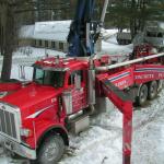 The concrete truck with huge boom is ready to pump the conrete into the pre-assembled forms that link together similar to "legos"